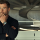 A pensive chris hemsworth with short hair